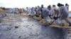 Volunteers remove oil-soaked beach sand near the Black Sea resort town of Anapa 